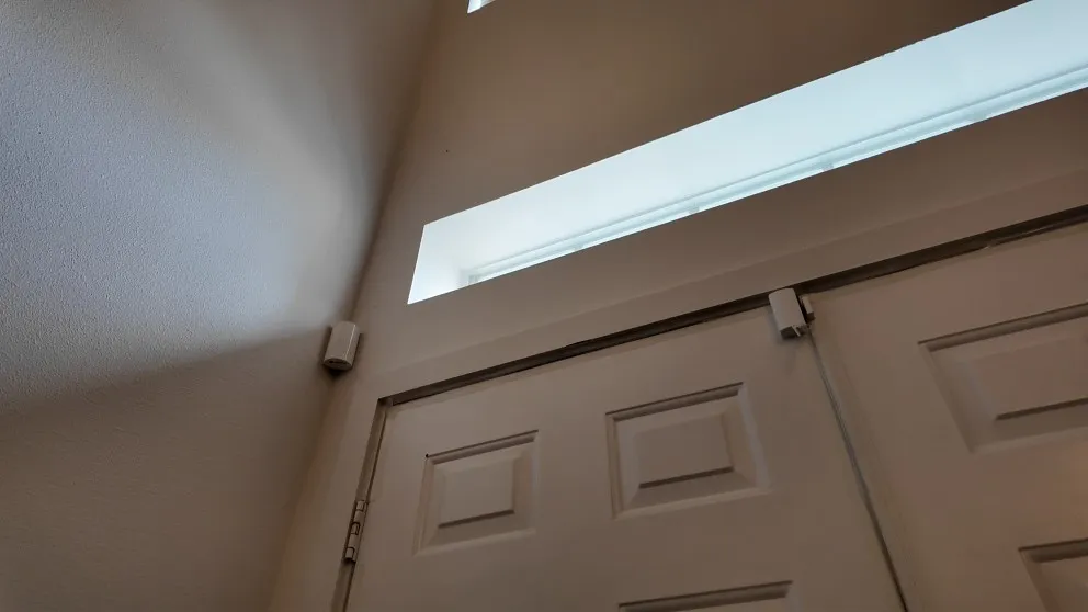 ADT door sensor installed on a door frame