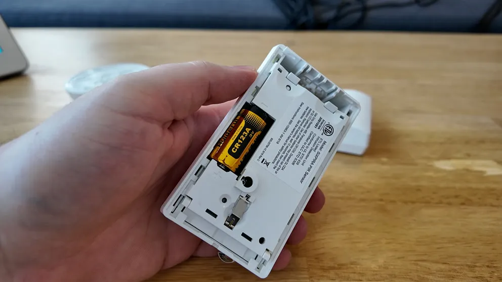 ADT motion detector opened showing CR123A battery