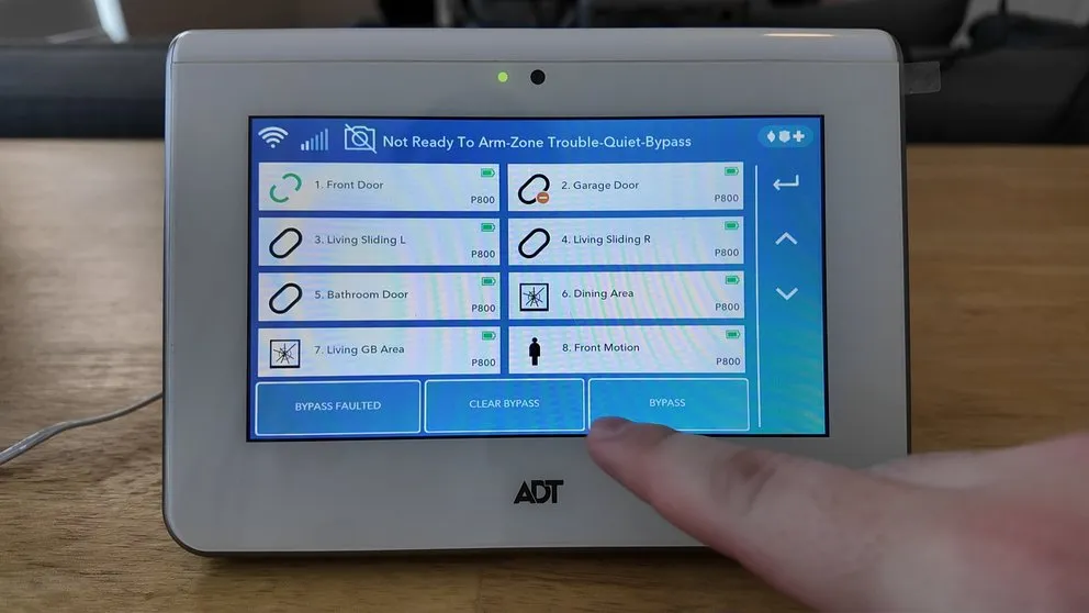 ADT panel showing bypass confirmation with Do Not Enter icon next to sensor