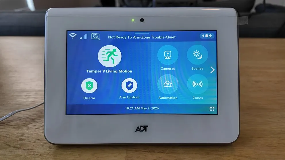 ADT panel home screen showing a tamper alert notification