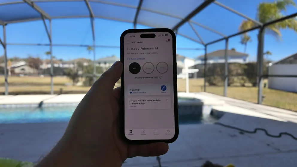 SimpliSafe app dashboard being used poolside outdoors