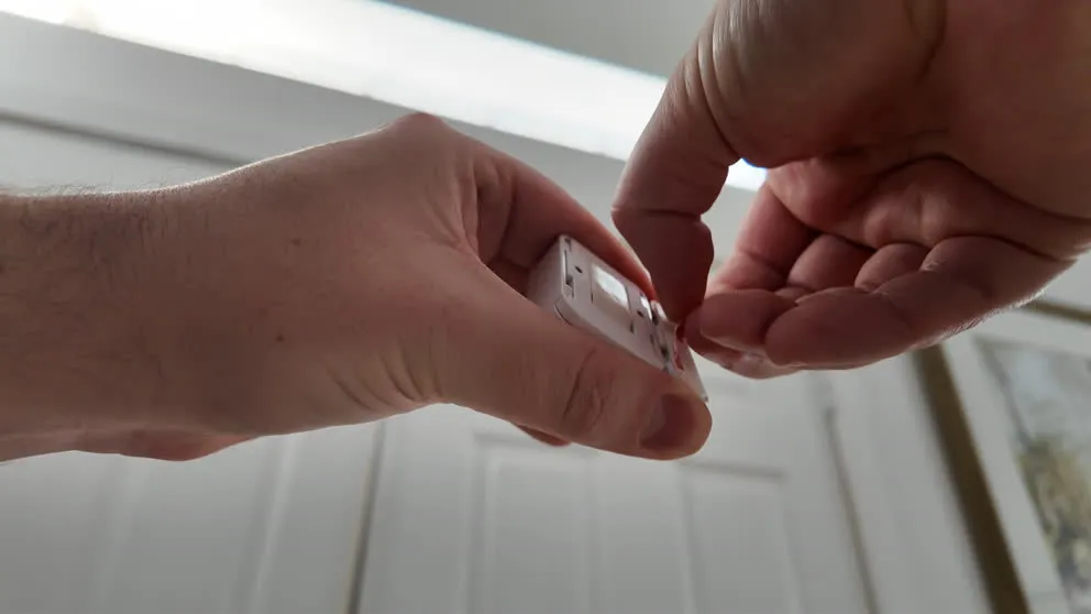 SimpliSafe entry sensor with battery being installed