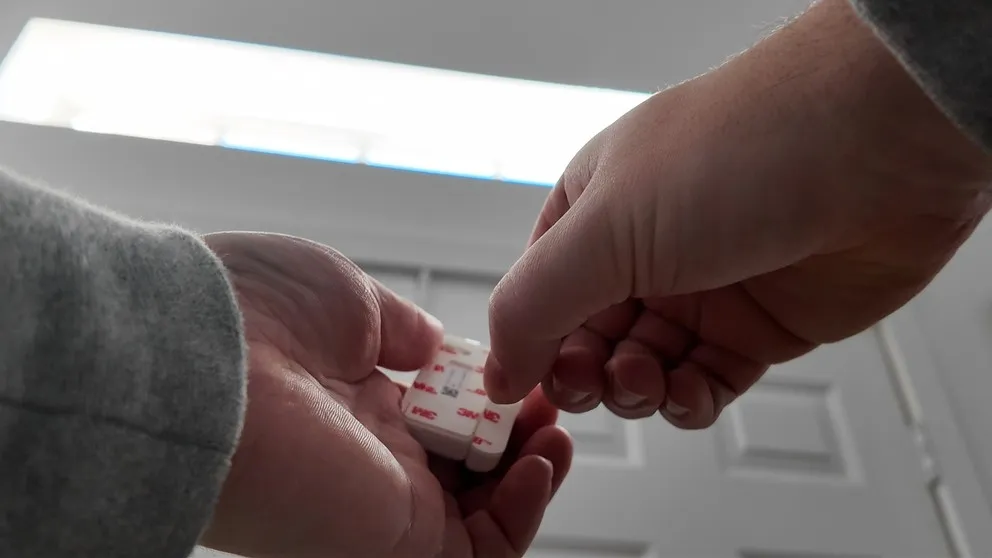 Peeling 3M adhesive backing from a Cove sensor